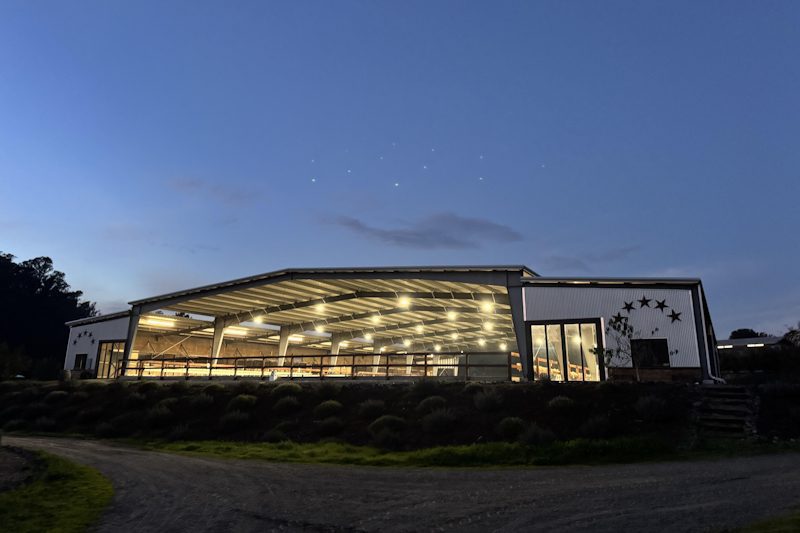 covered horse riding arena night